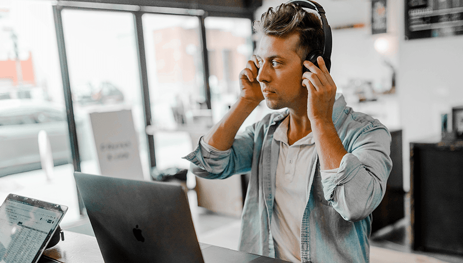 man with headphones on laptop