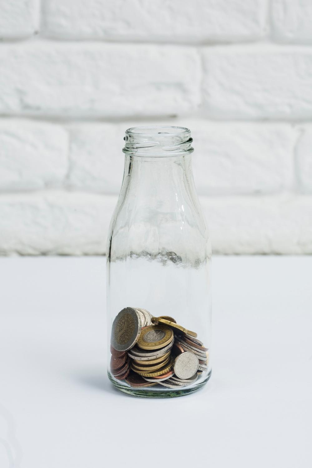 coins money in the glass bottle