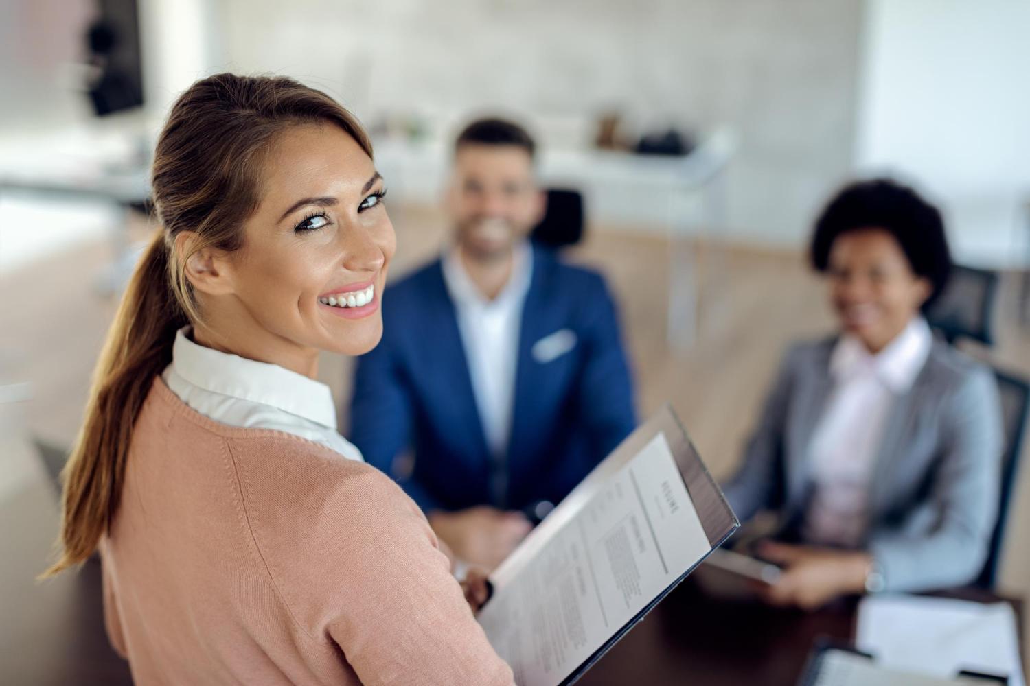 happy recruiter with two candidates