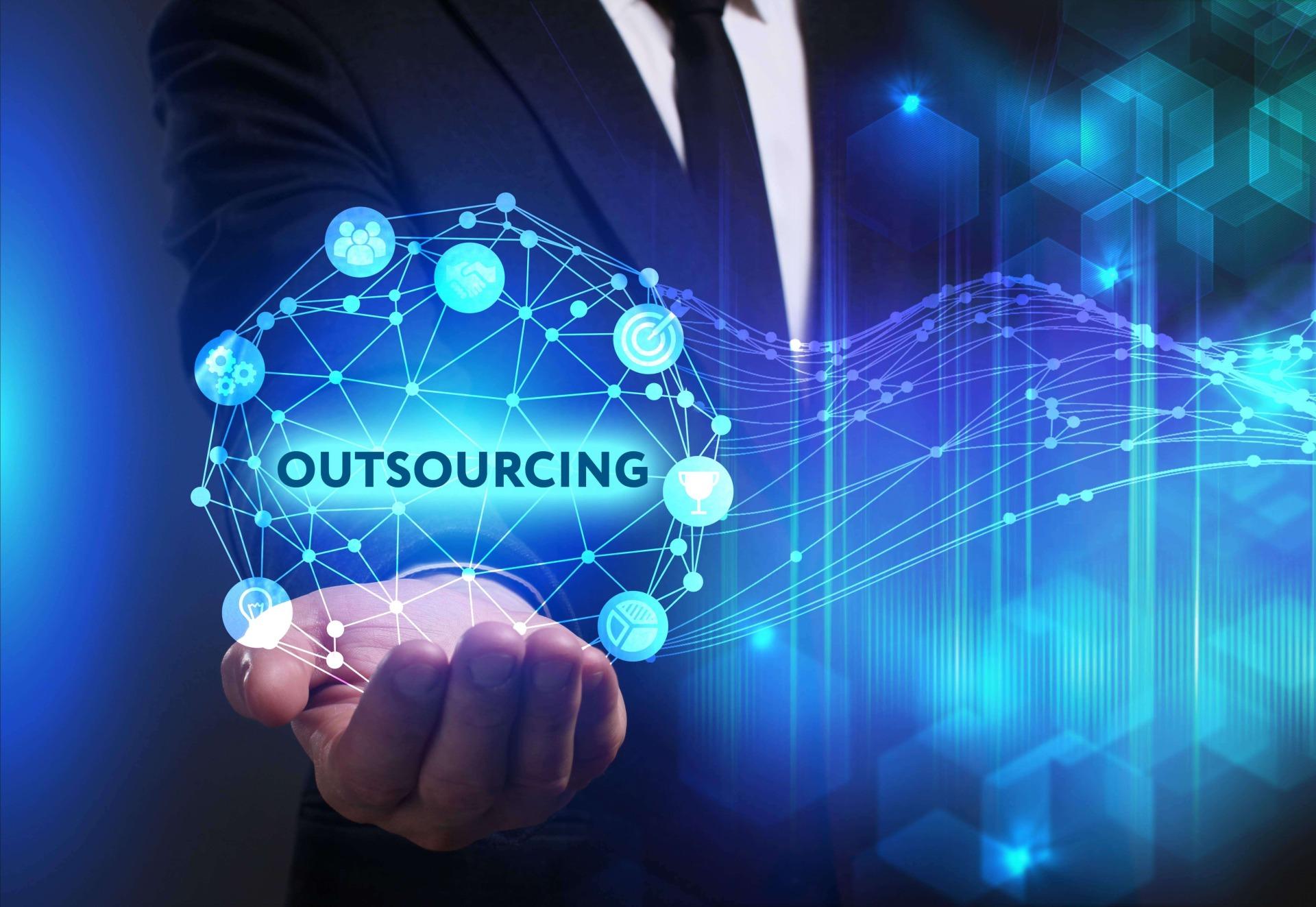 man holding a diagram in his hand showing outsourcing